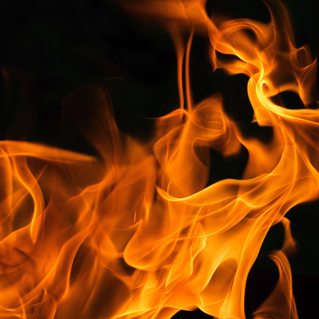 Close-up of bright orange and yellow flames against a dark background.
