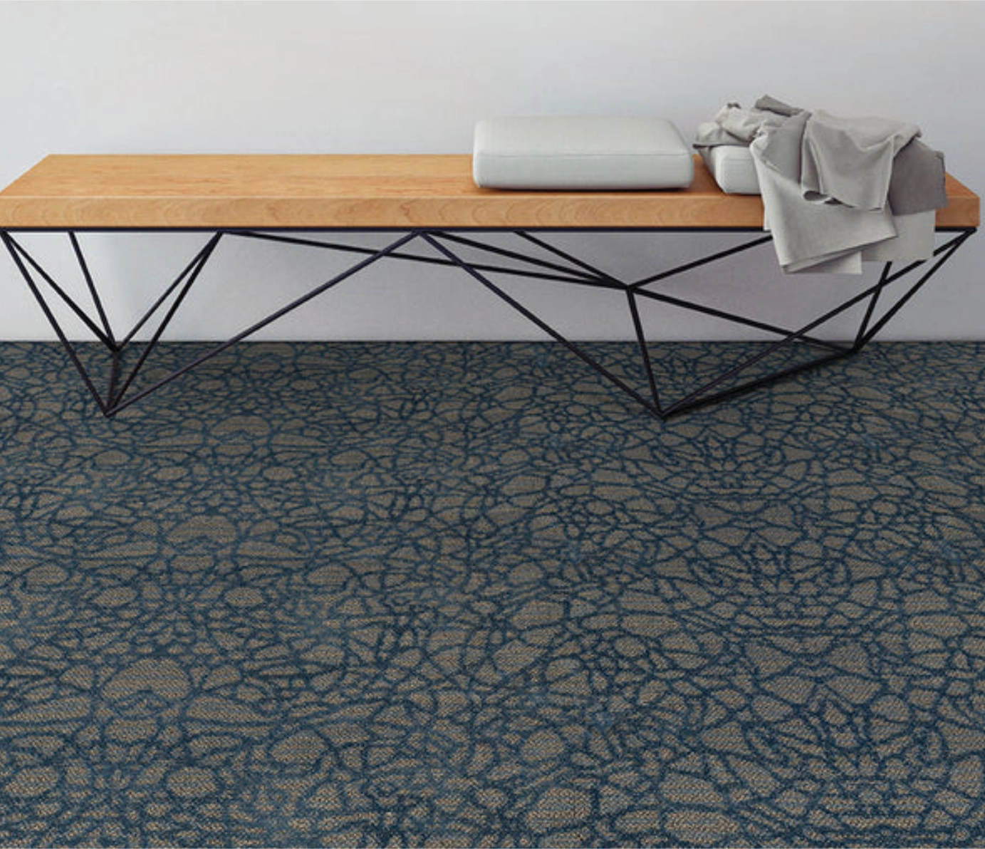 Blue swirl abstract pattern broadloom carpet in a room with a wood bench.